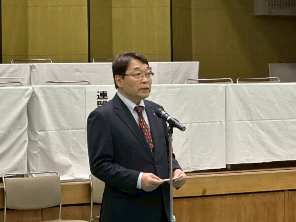 加藤勝信会長のご挨拶を川﨑雅雄副会長が代読